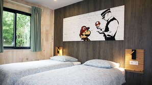 A bedroom with two beds, a large wall mural, and a window with curtains. - HOUSE WITH AIR CONDITIONING (Doucier)