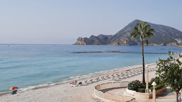 On the beach, sun-loungers