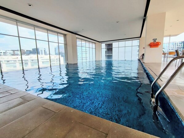 Enjoy a swim with panoramic city views from this spacious pool area.