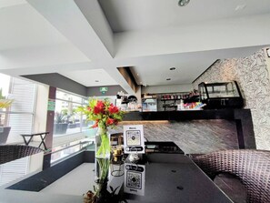 Check-in with ease at our lobby, featuring a digital reception desk and comfortable seating area with a view of the street.