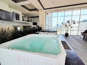 Relax by the pool with a view of the city.