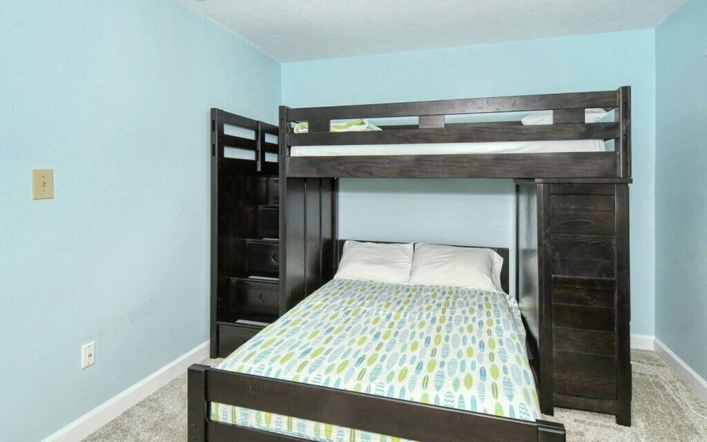 A bunk bed with a lower bed and a ladder.