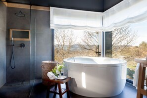 Tina con regadera, tina de hidromasaje, secadora de cabello, toallas 