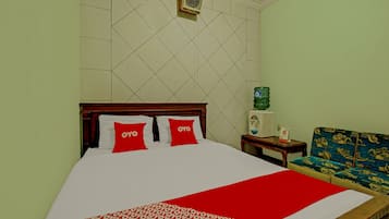A hotel room with a bed, a water dispenser, and a sofa.