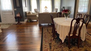 A dining area with a table set for four, surrounded by wooden chairs. - The Jackson House of Gamaliel (Gamaliel)