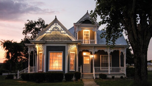 A two-story house with a porch, large windows, and a decorative front door. - The Jackson House of Gamaliel (Gamaliel)