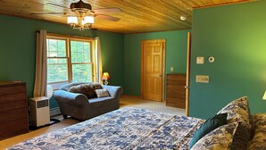 A bedroom with a bed, a chair, a dresser, a window, and a door. - Private quiet home close to Sunday River, Bethel village, and summer recreation  (Bethel)
