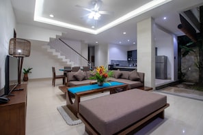 Relax in this spacious living room with a large sofa, coffee table, and flat-screen TV.