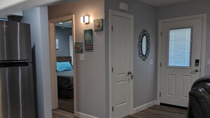 A kitchen with a stainless steel refrigerator, a granite countertop, and a wooden floor. - GORGEOUS 1 BED GUEST HOME (Alpine)