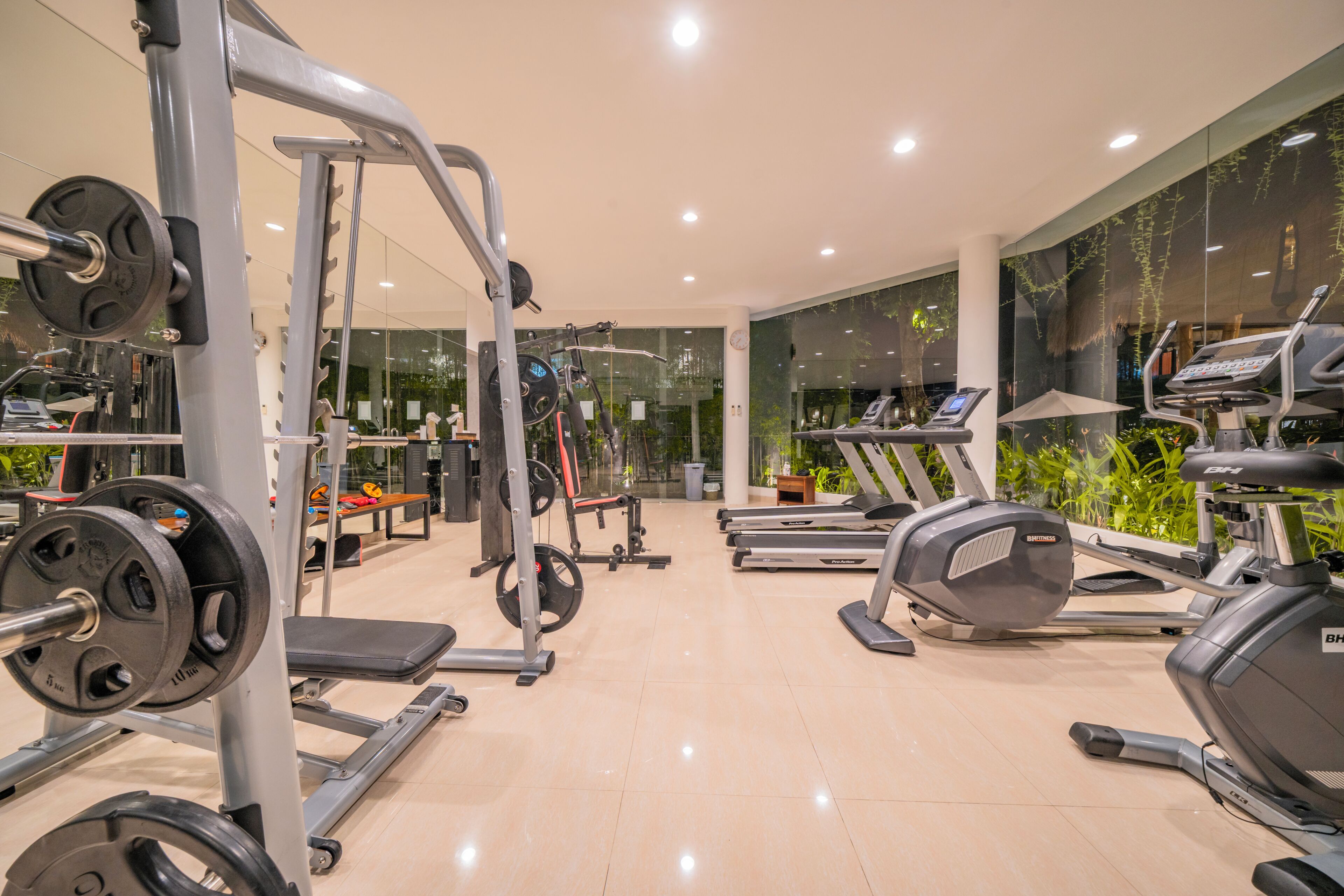 A gym with various exercise equipment, including treadmills and weight machines.