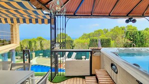 A pool area with a hot tub, lounge chairs, and a pergola with a striped awning. - Villa Sun Carlos by Solidays - Benissa, Costa Blanca (Benissa)