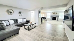 A modern living room with a sofa, coffee table, and a fireplace. - $0 Fees-Modern Home; Easy to Downtown/Scenic Trail (Northglenn)