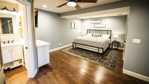 A bedroom with a bed, a ceiling fan, and a nightstand. - Farmhouse by the Lake with FAST Fiber Internet + Washer/Dryer! (Campton)