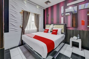 A hotel room with a bed, a bedside table, a mirror, and a window with curtains. - OYO 4010 Zaara Guest House Syariah (Padang)