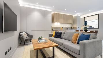 One Bedroom Apartment With Study | Living area | 49-inch Smart TV with digital channels, TV