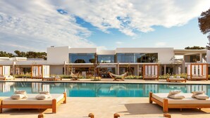 A modern hotel with a pool area, sun loungers, and a hammock. - Radisson Blu Resort, Al Hoceima (Ait Youssef Ou Ali)