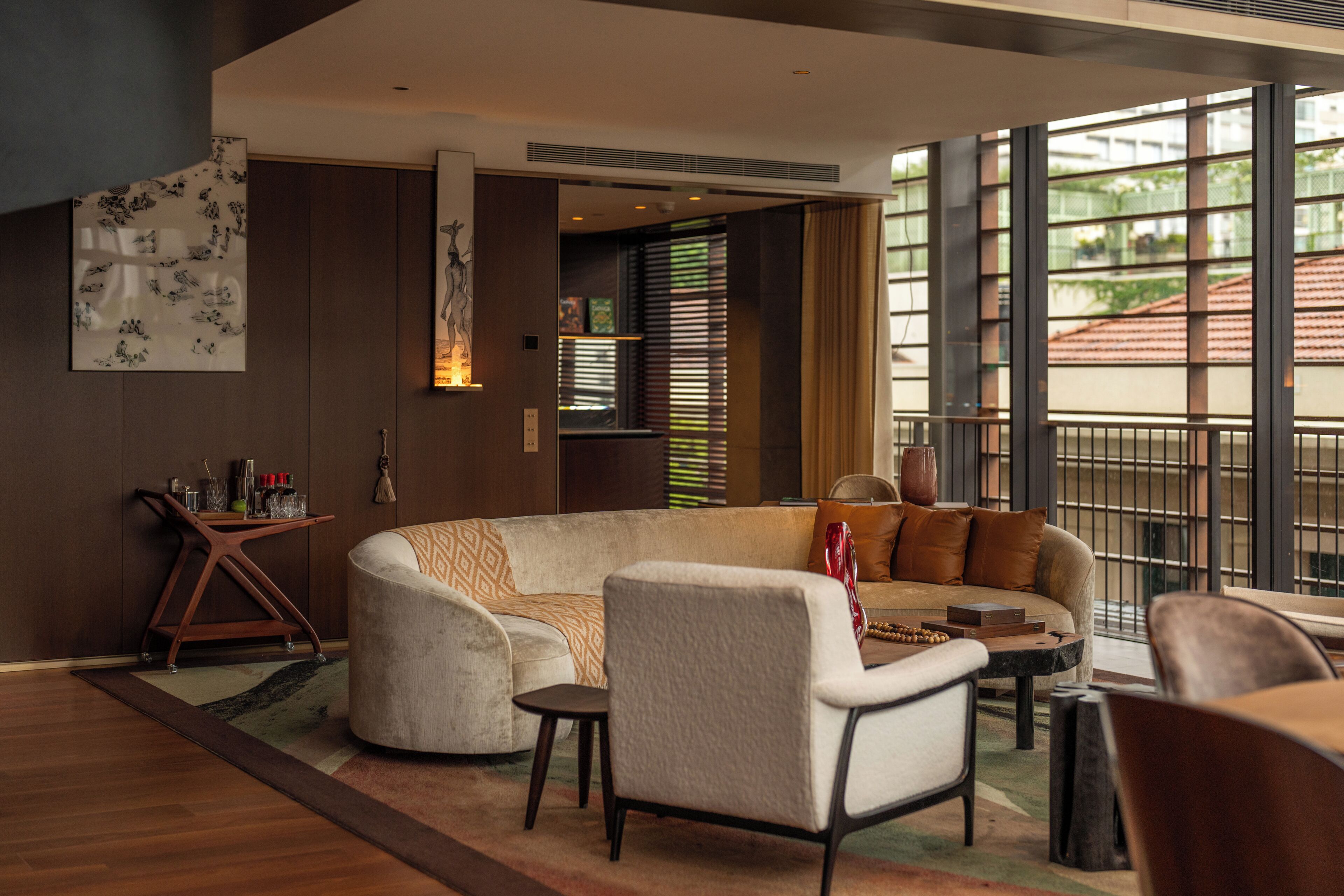 A modern living room with a sectional sofa, a coffee table, and a side table with decorative items.