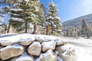 Experience the serene beauty of The Sequoia at Keystone Village, surrounded by snow-covered trees and a clear blue sky.