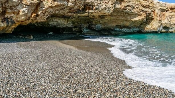 A pebble beach with clear turquoise water and a rocky cliff. - NEW Villa Sheila with private pool and BBQ. (Rethymno, Crete)