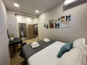 A hotel room with a bed, a desk, and a wardrobe. - NEW Villa Sheila with private pool and BBQ. (Rethymno, Crete)
