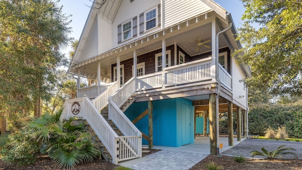 A two-story house with a covered porch, a staircase, and a blue door. - Prince's Folly! Walking Distance to Shops and Restaurants! (Folly Beach)