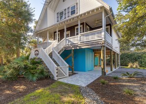 A two-story house with a covered porch, a staircase, and a blue door. - Prince's Folly! Walking Distance to Shops and Restaurants! (Folly Beach)