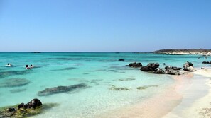 A beach with clear turquoise water, rocky outcrops, and a sandy shore. - ★ Only for 2 ★ cosy stone villa, totally private, pool, near sea, WiFi, parking (Chania)