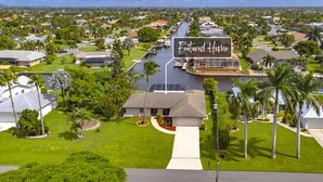 A residential area with a prominent house labeled "Featured Home." - Look at this View with direct Gulf Access (Cape Coral)