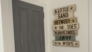 A door with a rustic sign on the wall beside it. - Immaculate cosy comfortable home, central location (Inverbervie)