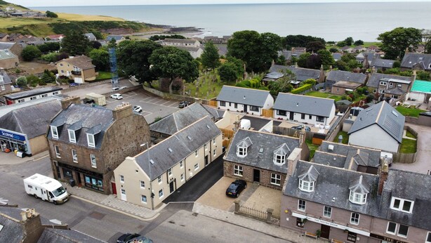 A coastal town with a mix of residential and commercial buildings, including a pub named 'The Tasting Room'. - Immaculate cosy comfortable home, central location (Inverbervie)