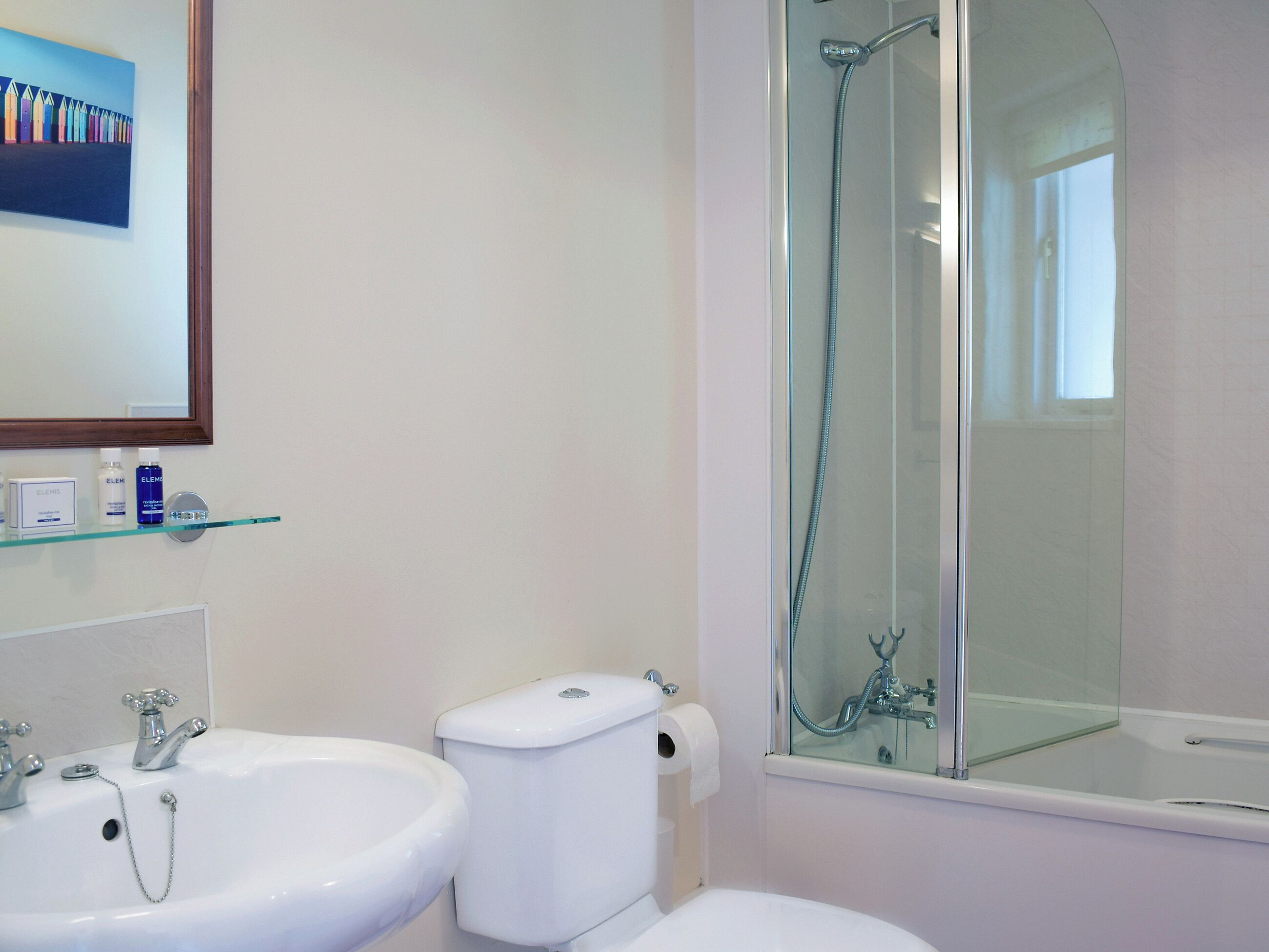 A bathroom with a sink, toilet, and shower.