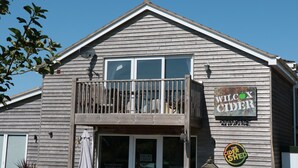 A wooden building with a sign reading "Wilco Cider" and a sign for "The Cider Shed". - The Cider Shed (Winscombe)