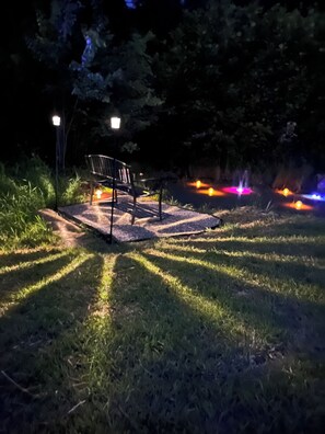 A bench in a park at night with lights in the background. - Home in the heart of West Virginia adventure country! (Mount Hope)