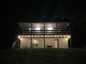 A two-story building with a balcony, a staircase, and a bench. - Boats n’ Slopes  ~4 season secluded cottage (Union Dale)