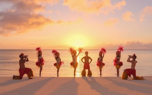 A beach scene with people in traditional attire. - Crowne Plaza Saipan (Saipan)