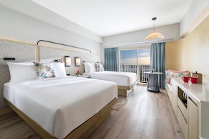 A hotel room with two beds, a balcony, a dining area, and a view of the sky.