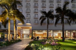 A hotel with a modern exterior, multiple balconies, and a well-maintained garden area. - Crowne Plaza Saipan (Saipan)