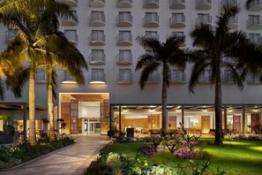 A hotel with a modern exterior, multiple balconies, and a well-maintained garden area. - Crowne Plaza Saipan (Saipan)
