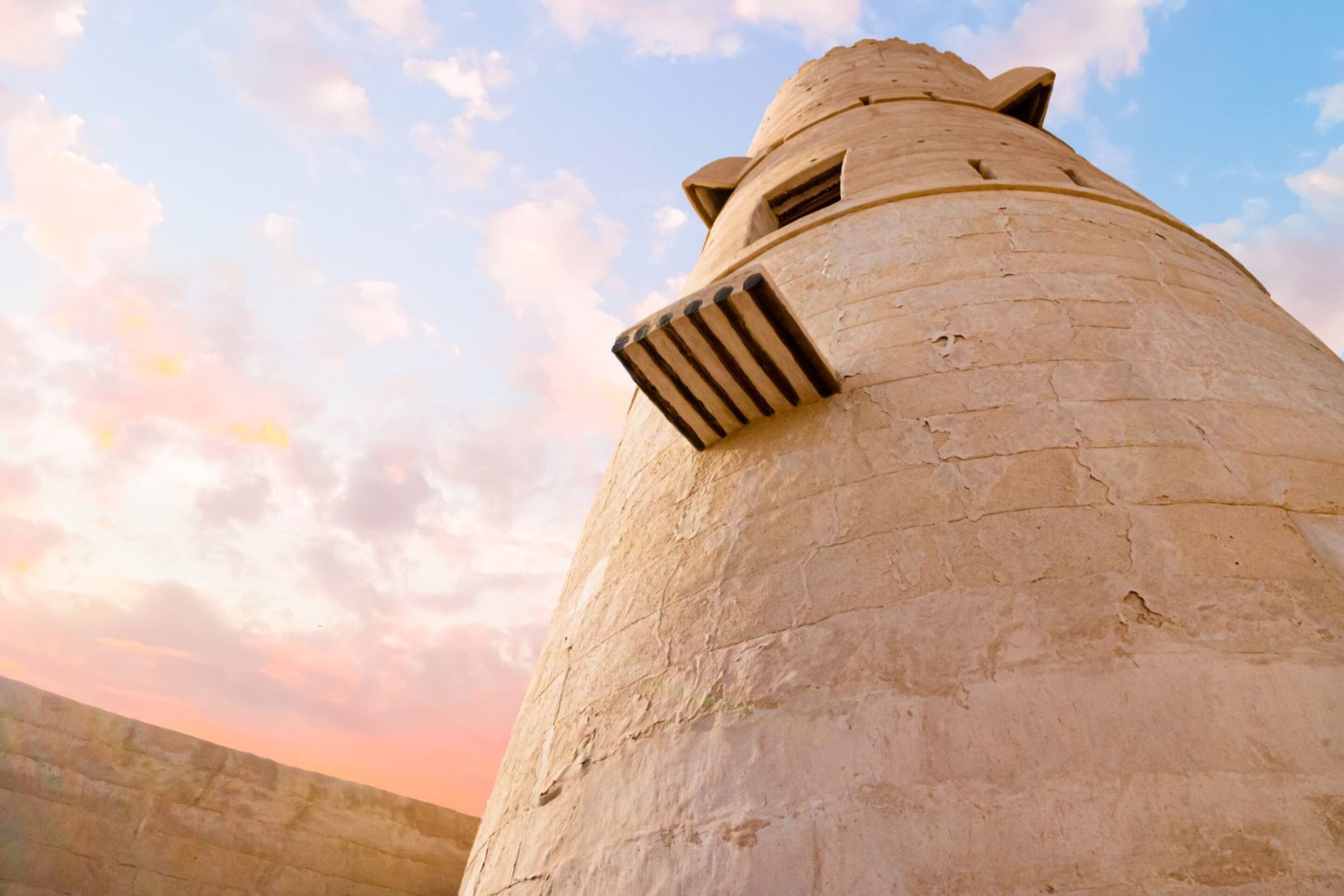 A large, cylindrical stone structure with a flat top and a small window.