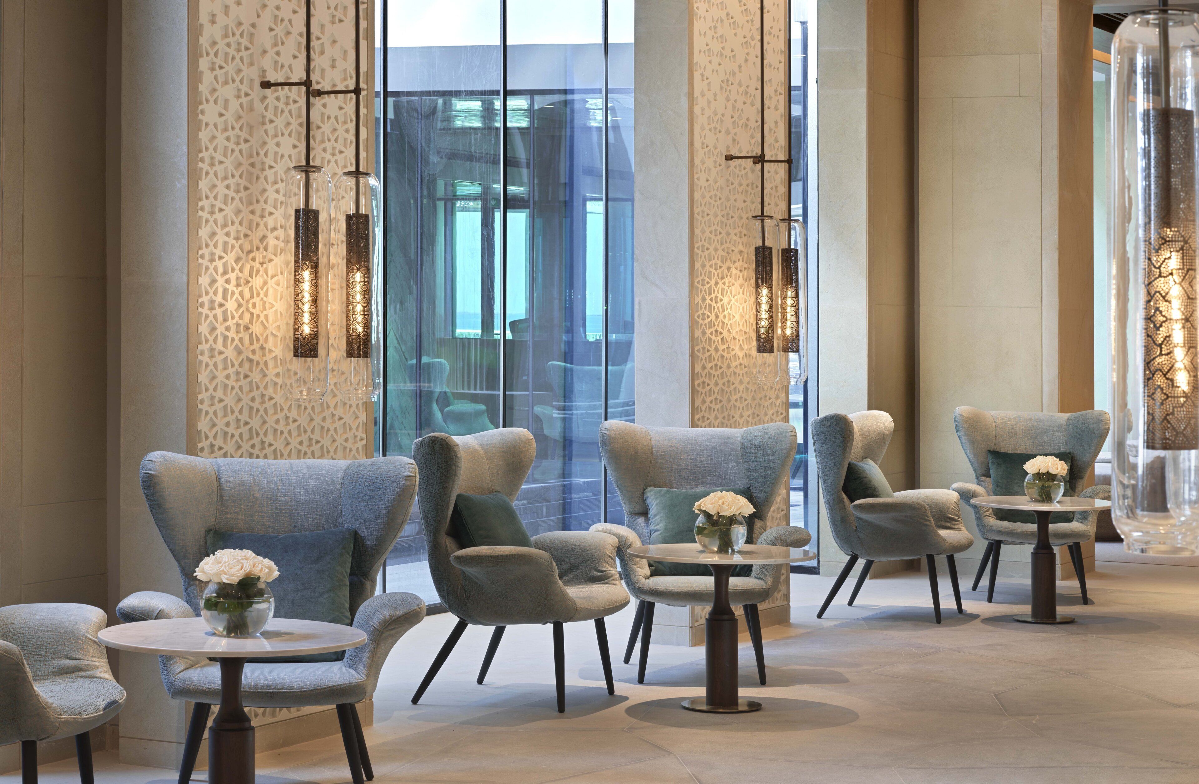 A modern interior with seating arrangements and decorative lighting.