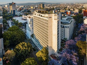 A high-rise building with a modern architectural design, featuring a prominent glass facade and a rooftop terrace. - Andaz Condesa Mexico City, By Hyatt (Mexico City)