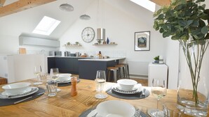 A modern kitchen with a dining area set for a meal. - Birch House, situated just outside of the beautiful lively village of St Agnes and only 1.5 miles fr (St Agnes)