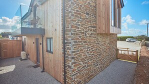 A modern building with a stone facade, a wooden exterior, and a glass balcony. - Birch House, situated just outside of the beautiful lively village of St Agnes and only 1.5 miles fr (St Agnes)