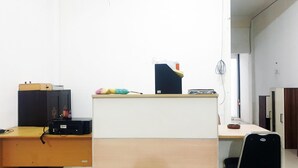 A small office with a desk, a chair, and a filing cabinet. - OYO 3508 Griya Aisyah Karah Syariah (Surabaya)