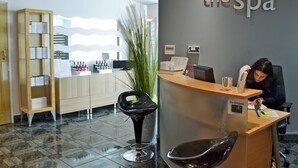 A reception area with a counter, a reception desk, a chair, a plant, and a wall with the text "the spa". - The Corn Store - UK6716 (Lydstep, near Tenby)