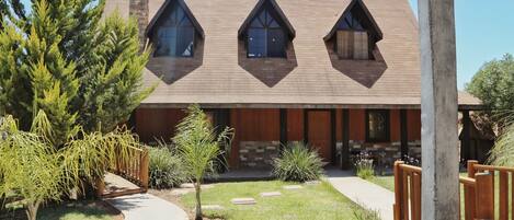 A modern building with a sloped roof and triangular windows.