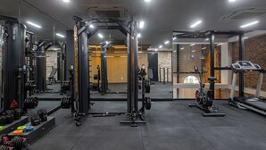 A gym with weightlifting equipment, treadmills, and exercise bikes.