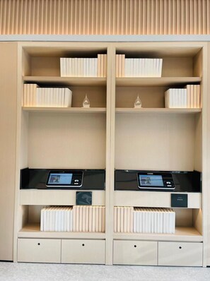 A modern, symmetrical bookshelf with multiple shelves, integrated electronic devices, and a minimalist design. - Ji Hotel Dongtai (Yancheng)