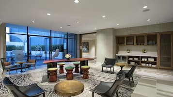 Enjoy meals together at the large dining table surrounded by comfortable seating and a shelving unit.