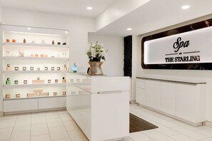 A spa reception area with a reception desk, shelves with spa products, and a sign reading "Spa at The Starling".